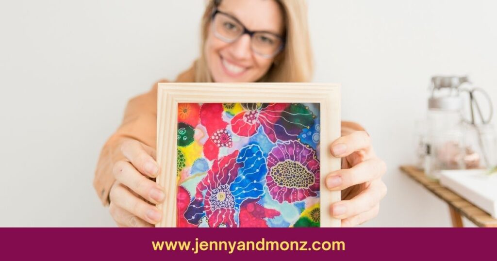 happy woman showing simple artwork encased in wood frame for bedroom wall decor