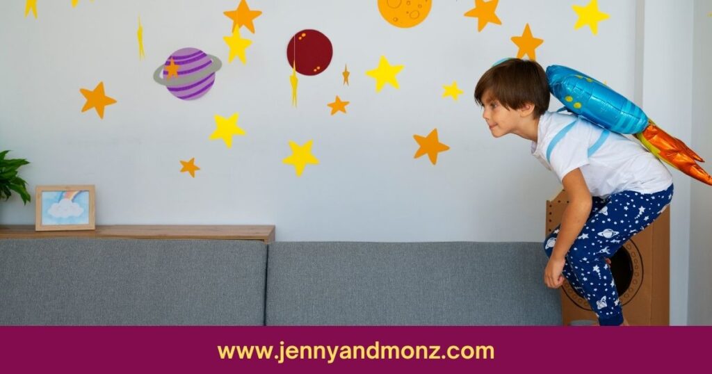 kid playing in the room decorated with stars and planets above sofa 