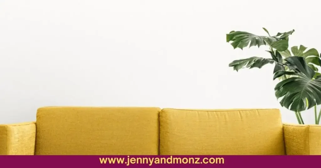 Plants on wall behind yellow couch
