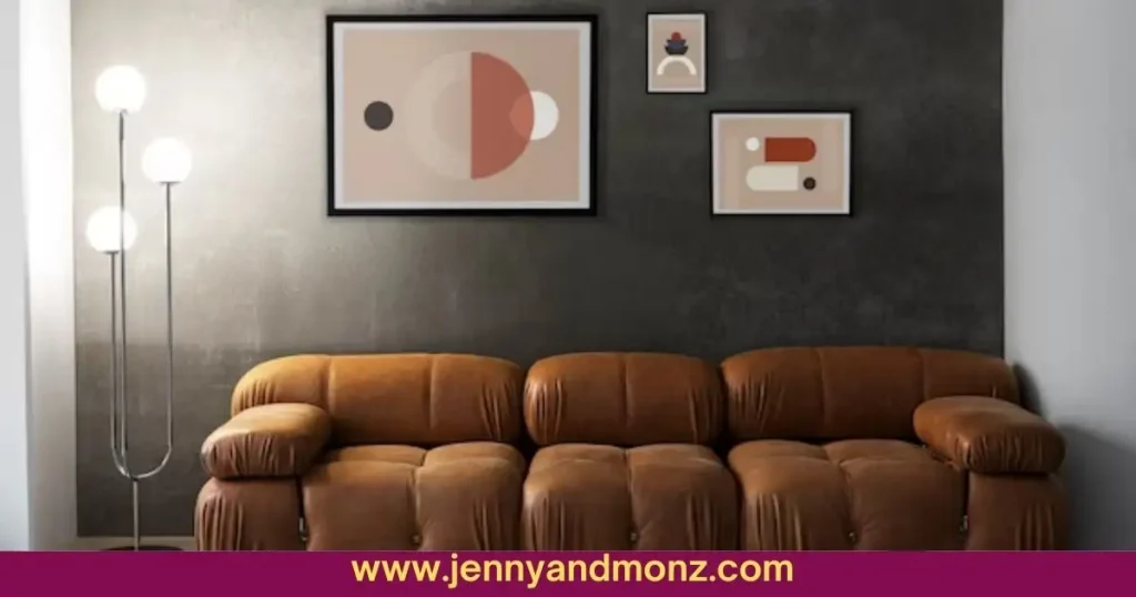 Three frames on wall behind brown leather couch