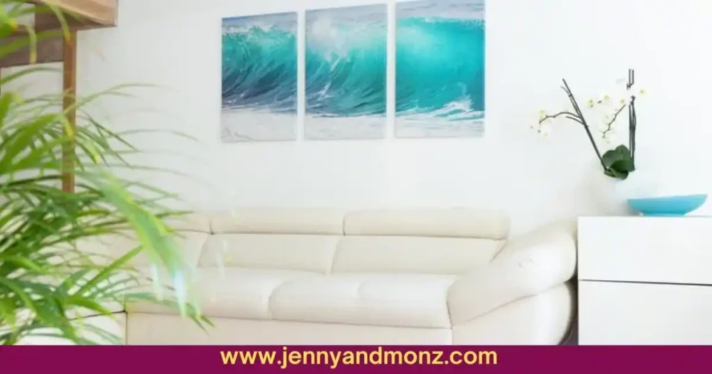 Wall art in frames behind white couch