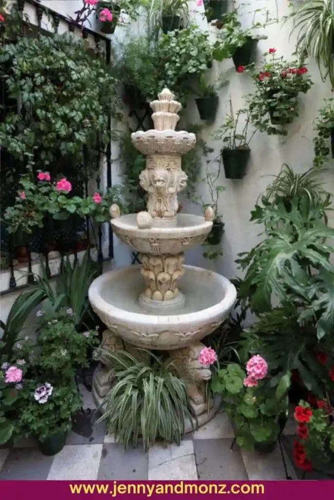 Hanging Flower Pots on the Wall with a Fountain