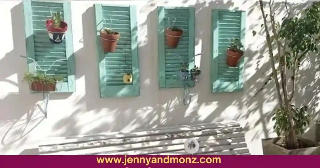 Outdoor wall decorated with recycled shutters and flower pots