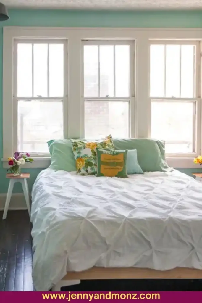 Small bedroom painted in seafoam green and white color